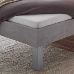 Bett in Betonoptik mit Kopfteil Kissen - Rienas^Wohnen Outlet